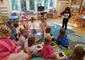 Zajęcia twórcze z mamą Janki - dziewczynka prezentuje pracę